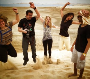 group of people jumping in qatar desert