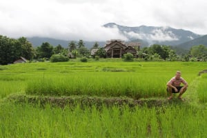 guy in a field outside in thailand