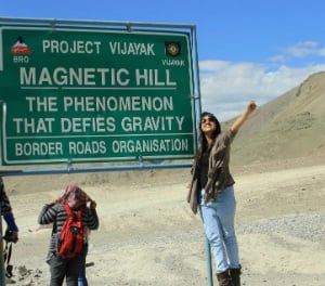 woman by the magnetic hill sign project vijayak