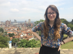 woman smiling with city behind her