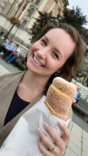 woman holding a pastry