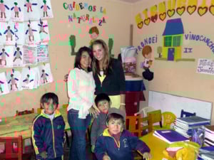 woman in classroom with teacher and kids
