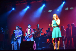 woman singing on stage