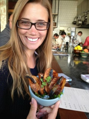 woman smiling with appetizer