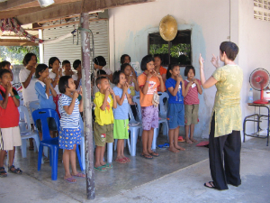woman teaching children