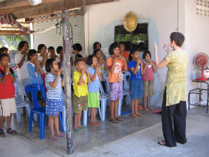 woman teaching children