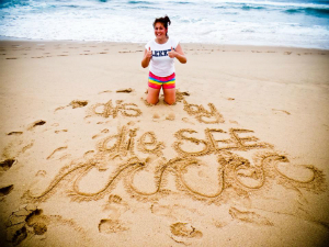 woman thumbs up on beach