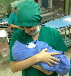 Gemma holding a newborn baby