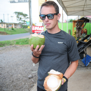 guy drinking out of a coconut