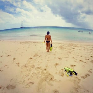 A young woman standing on the beach.