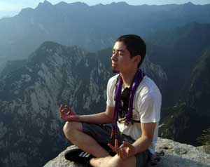 man meditating on mountain