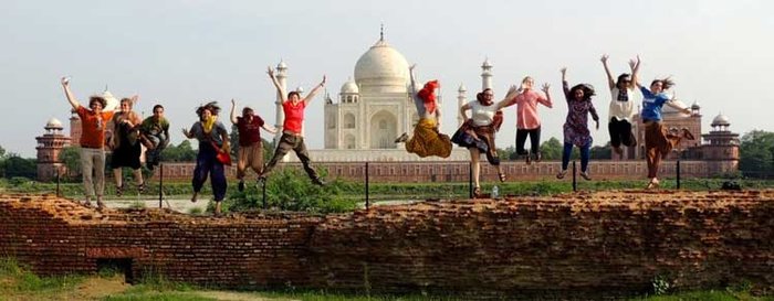 students jumping at taj mahal