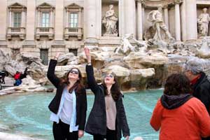 girls in front of fountain in rome