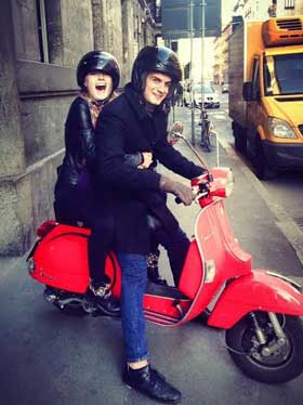 man and woman on vespa