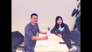 A student with his teacher sitting at a table 