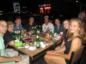 A group of people eating together in a restaurant