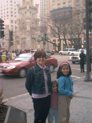 woman with her kids smiling in the city