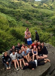 Group picture on top of a waterfall in the highlands of Fiji.