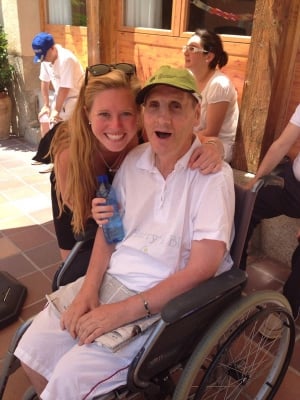 woman helping an elderly man in a wheelchair