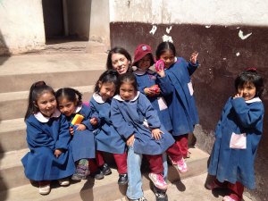 Lissette surrounded by kids.