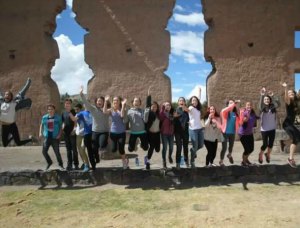 The whole group taking a jumping picture at the Incan ruins in Raqchi.