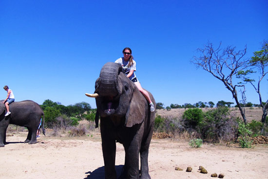 Chelsi riding an African elephant in South Africa