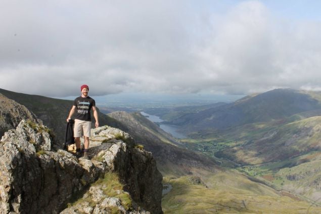 guy smiling on a mountain