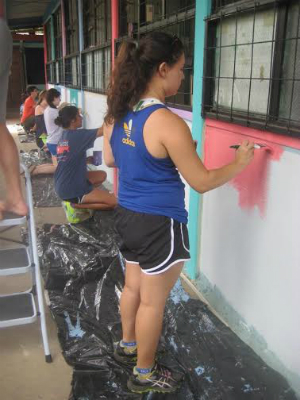girl painting a house