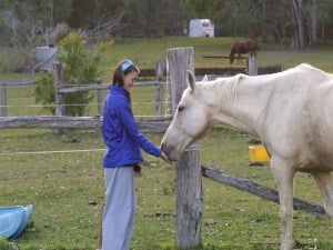 Jenny playing with a horse at Jabiru
