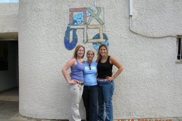 Volunteers in front of the mural they made as part of a beautifying project