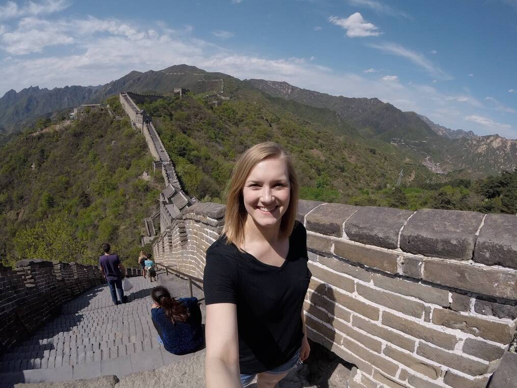blonde woman taking selfie on Great Wall of China