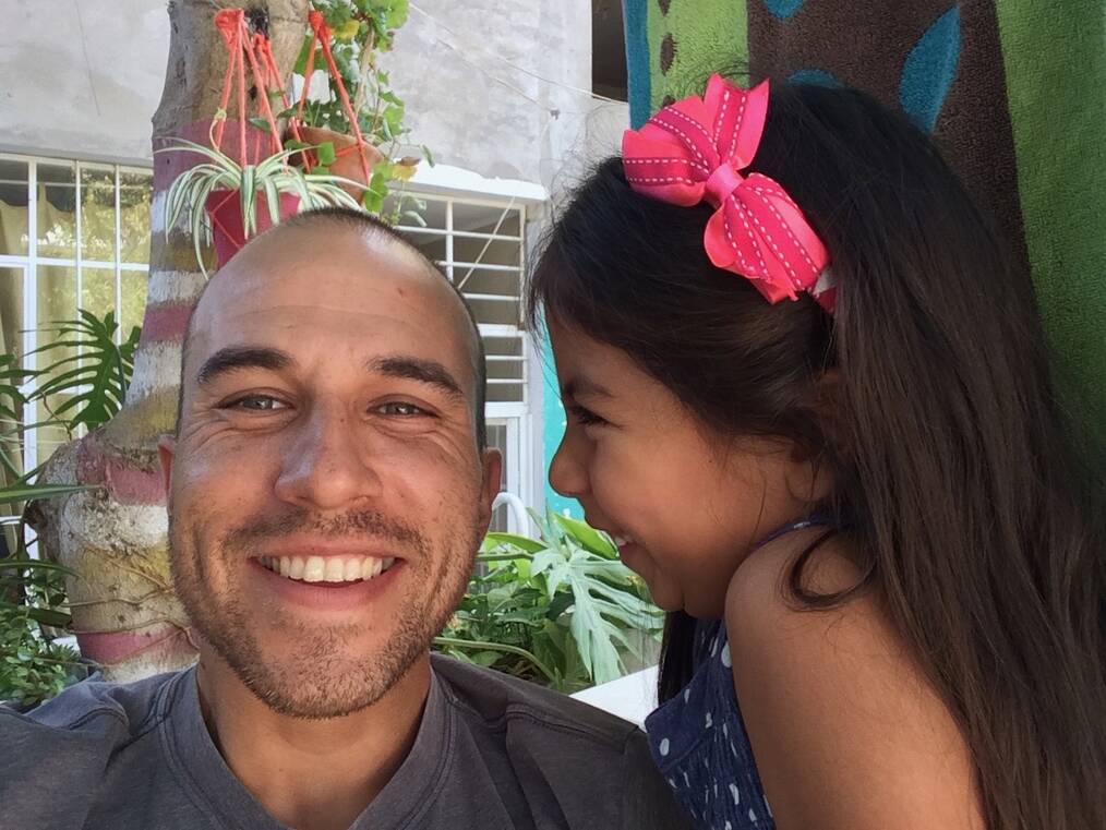 man and young girl with pink bow