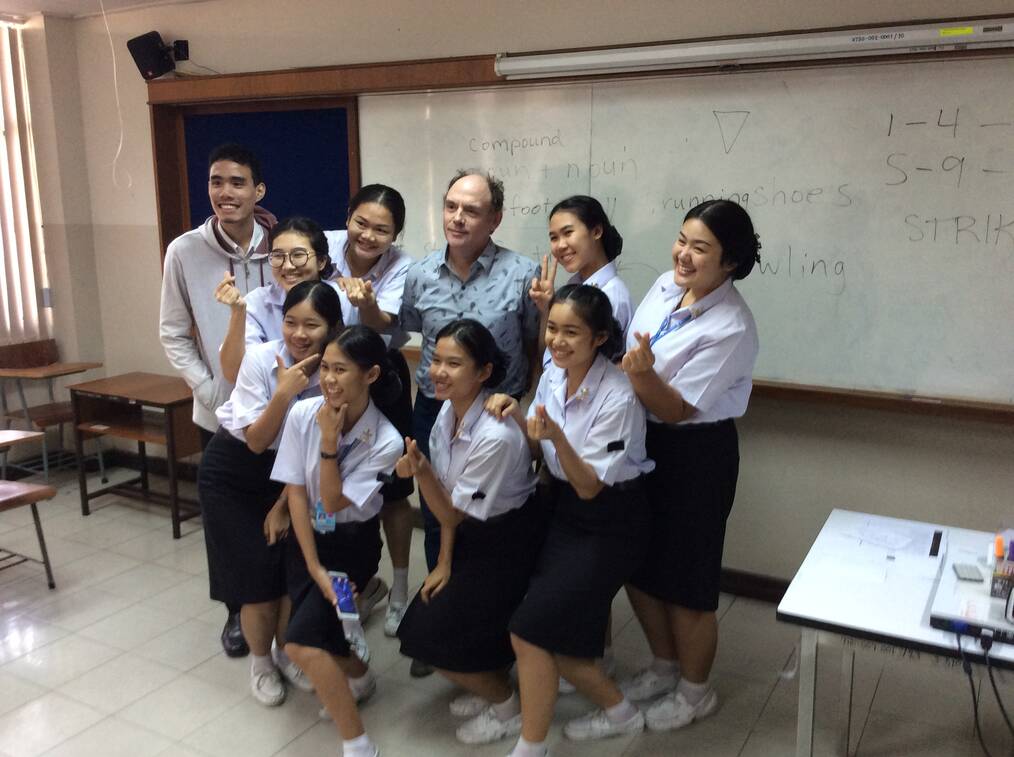 American ESL teacher with Thai students in classroom