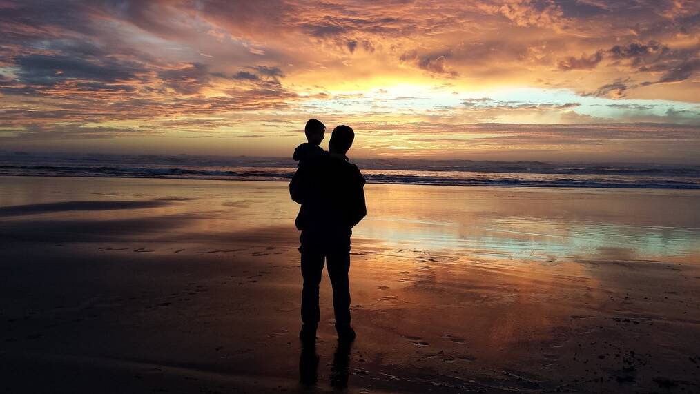 All About Teach Abroad with a Family: Man and Son at Sunset