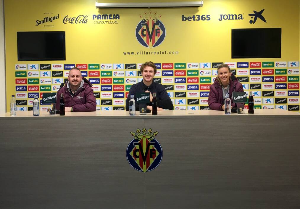 Three interns sitting at a desk.