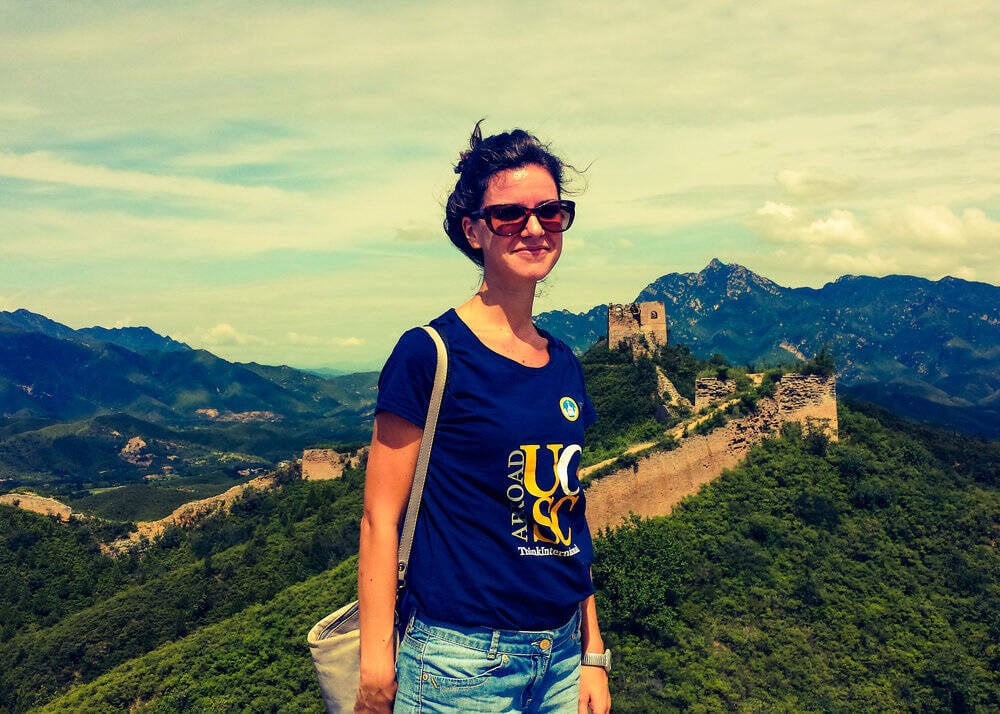 Woman standing in front of The Great Wall of China.