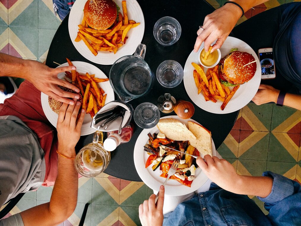 Photo by Dan Gold on Unsplash Four plates of food on a table.