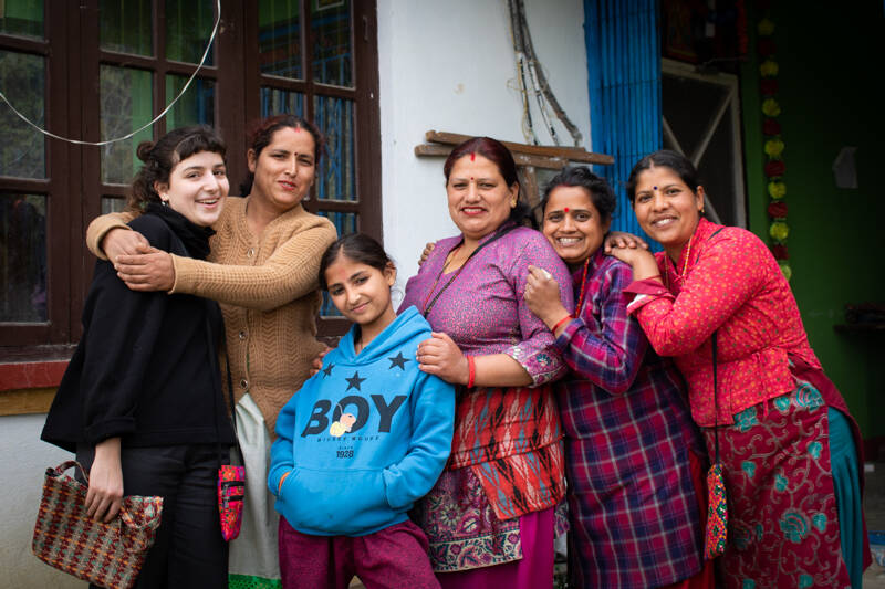 Six women smiling and posing.