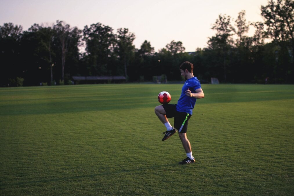 Photo by Ruben Leija on Unsplash Man balancing a soccer ball on his leg.