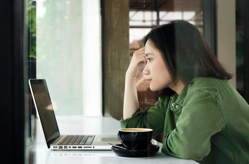Person using laptop at coffee shop