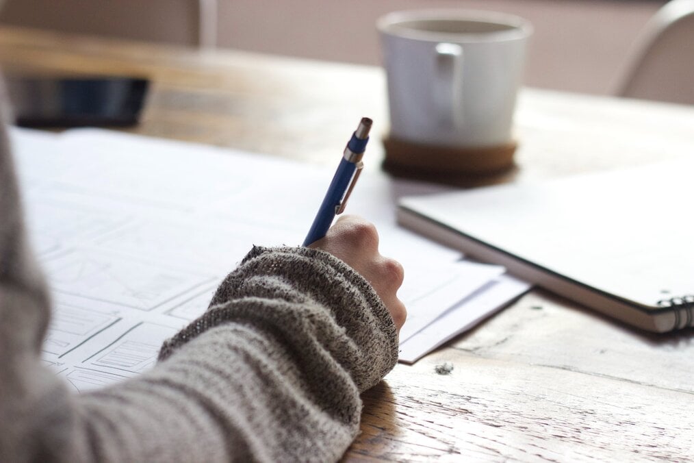 Person writing and taking notes
