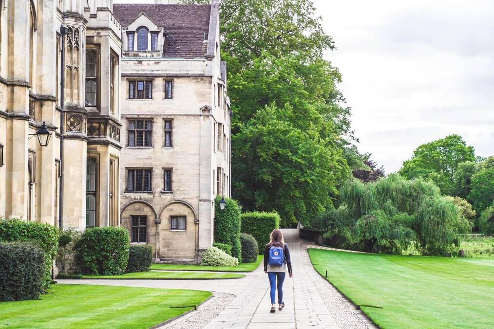 Student walking near university building.