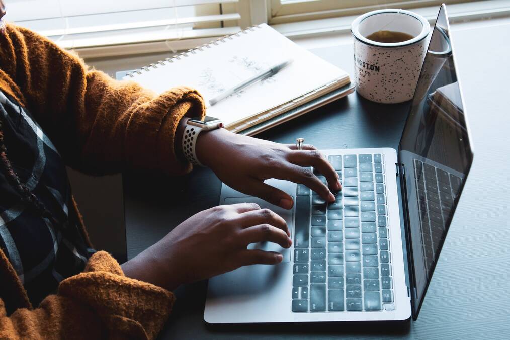 Someone typing on a laptop.