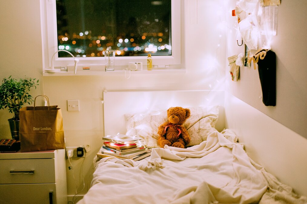 Bedroom with string lights and teddy bear
