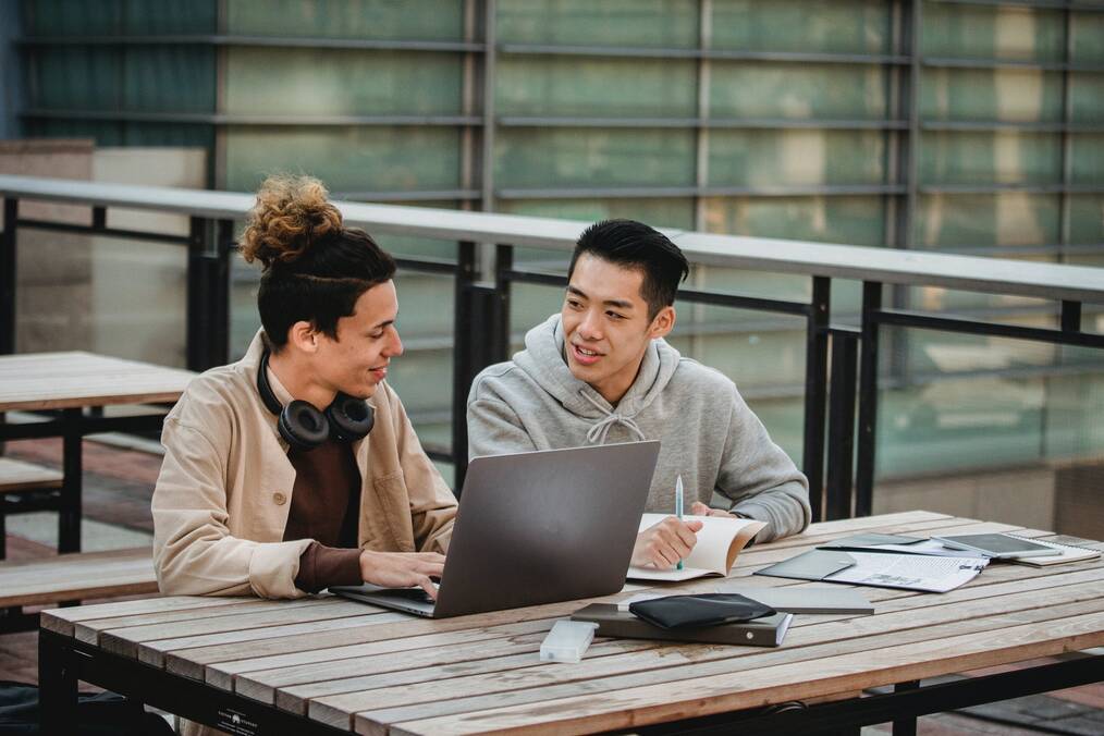 2 male students studying together