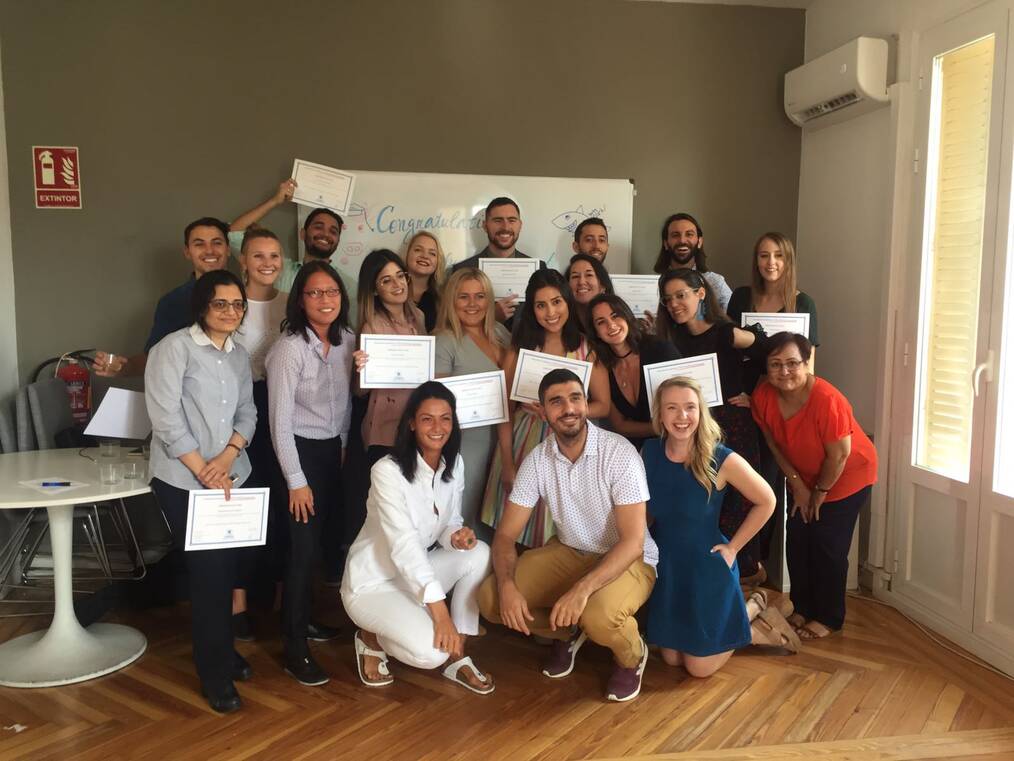 Group of people holding TEFL certificates.