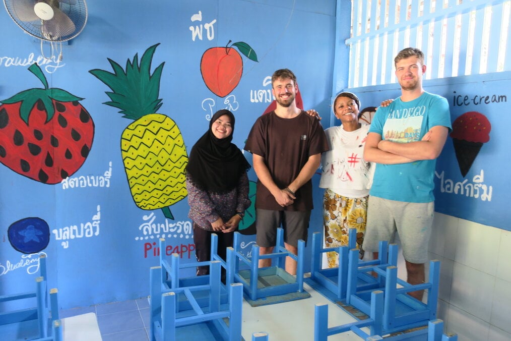 Group of volunteers smiling in classroom