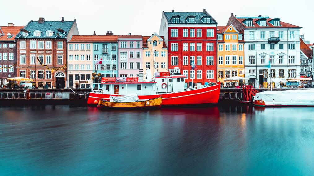 Colorful building over water with boat in front