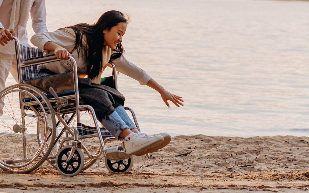 Person in wheelchair on sand