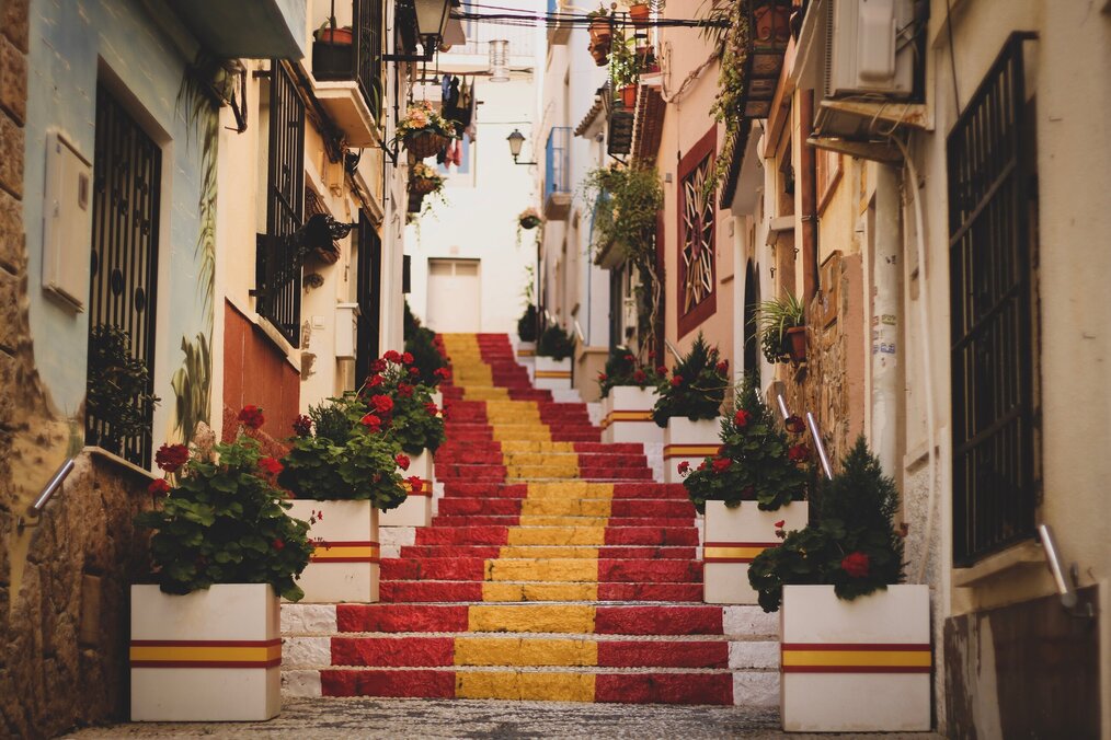 Red and yellow painted stairs outside in an alley